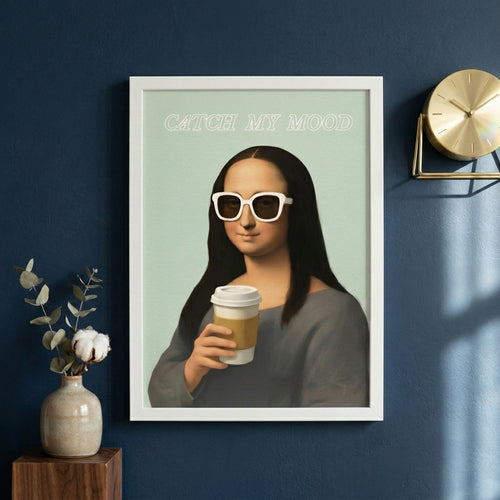 Framed artwork of a stylized Mona Lisa holding a coffee cup with 'Catch My Mood' text on a blue wall.