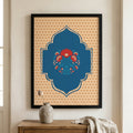 Framed Islamic wall art featuring a blue central arch with floral motifs on a beige patterned background, displayed on a wall above a wooden console table with a vase and cloth.