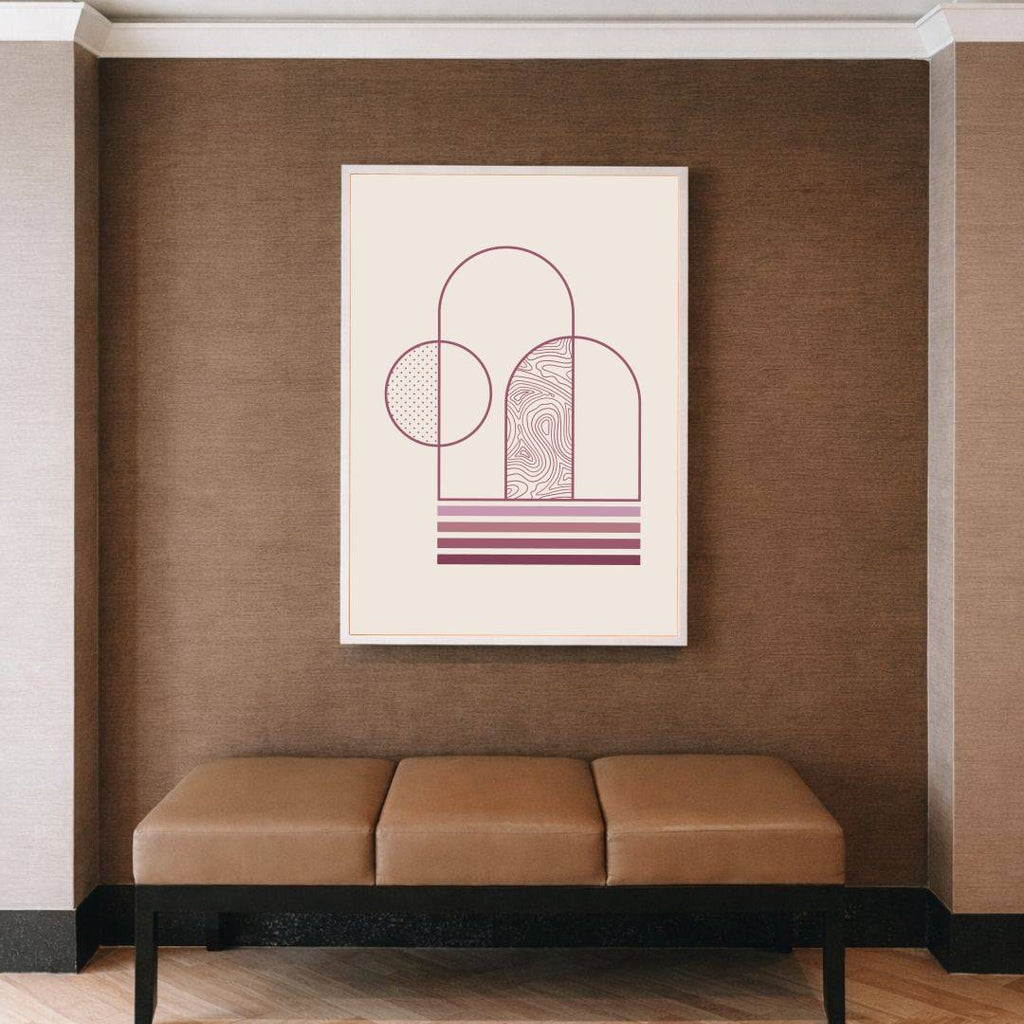 Framed abstract art on a brown wall above a beige bench.
